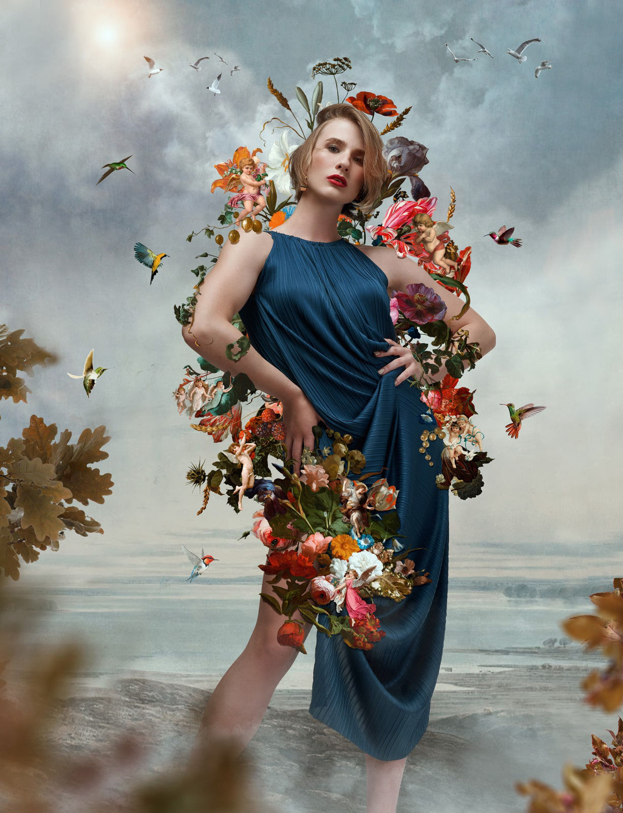 Painterly photography of a caucasian model wearing a blue tunic surrounded by flowers and hummingbirds 
