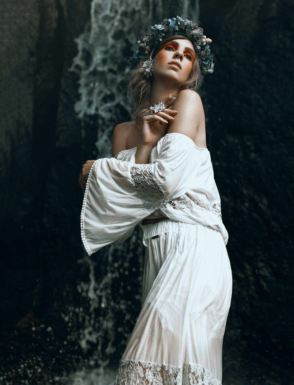 Fine art photography of a model wearing a white dress in waterfalls