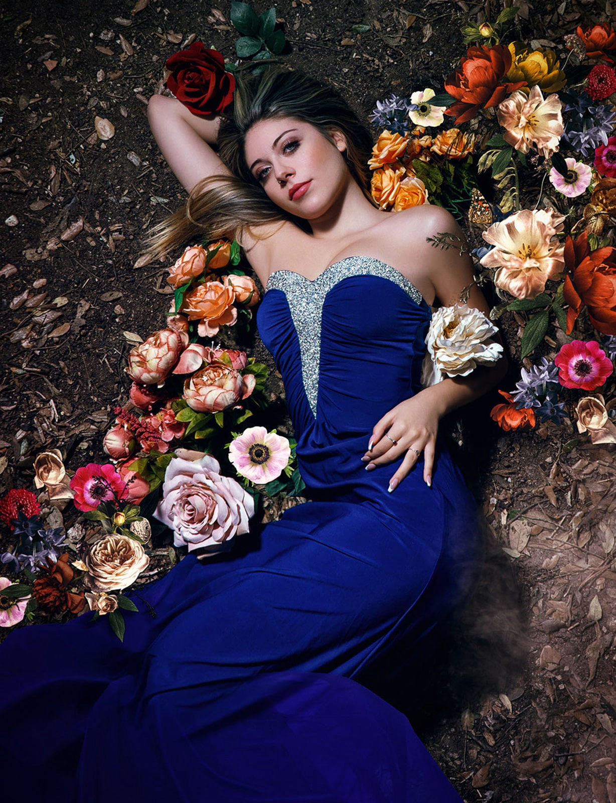 Fine art photography of a model wearing a blue dress with flowers 