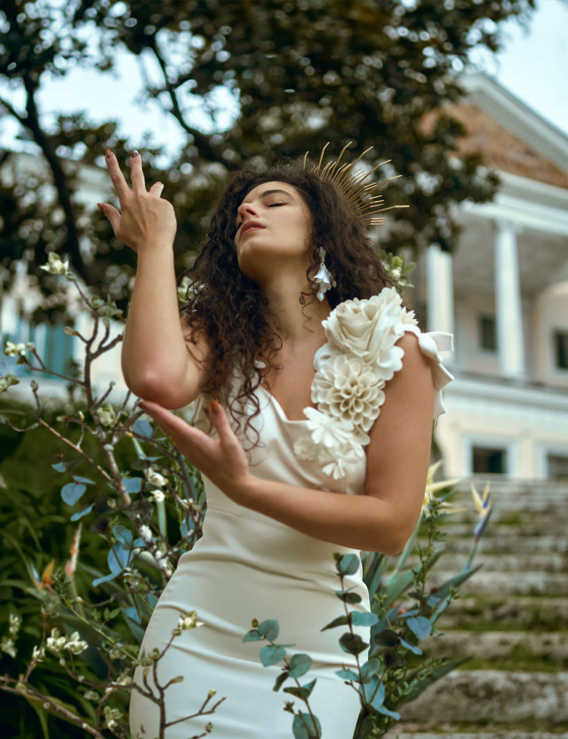 Picture of a model surrounded by flowers 