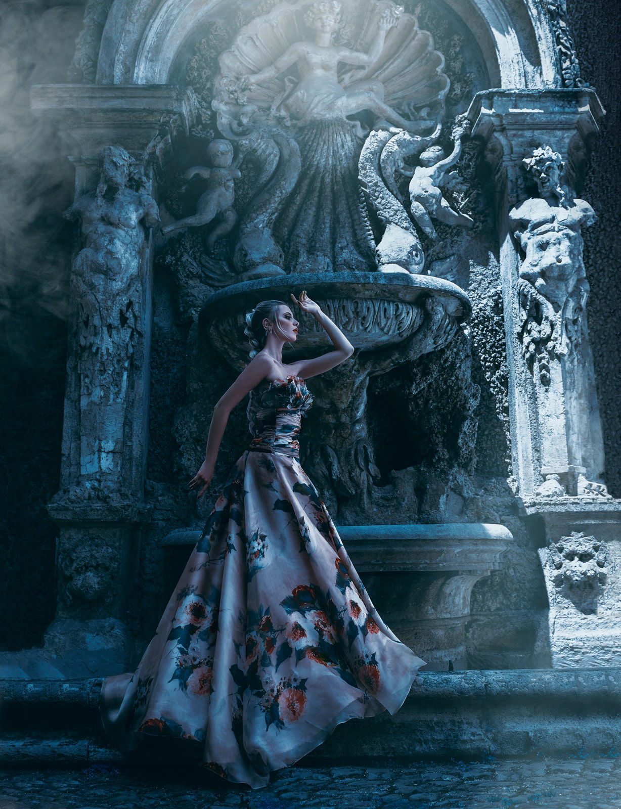 Fine art photography of a model posing in front of an ancient fountain