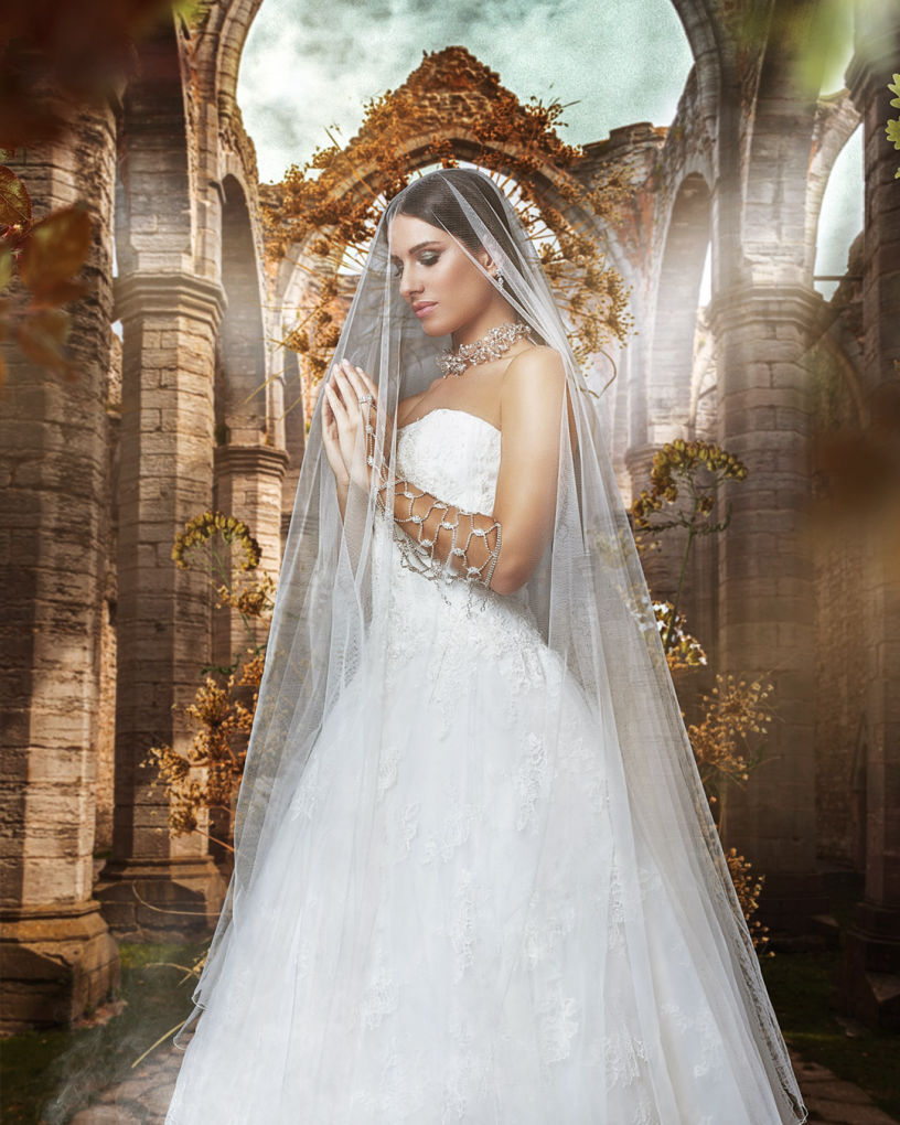 A model wearing a white weeding dress is praying in an abandoned ruined church surrounded by flowers