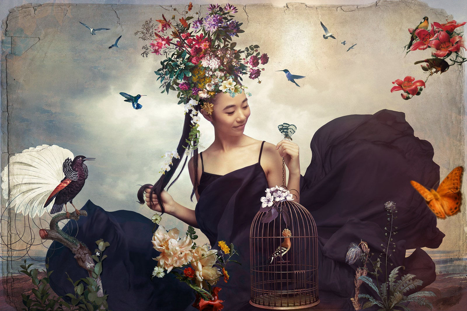 Painterly photography of a cinese model wearing a black long dress surrounded by flowers and hummingbirds 