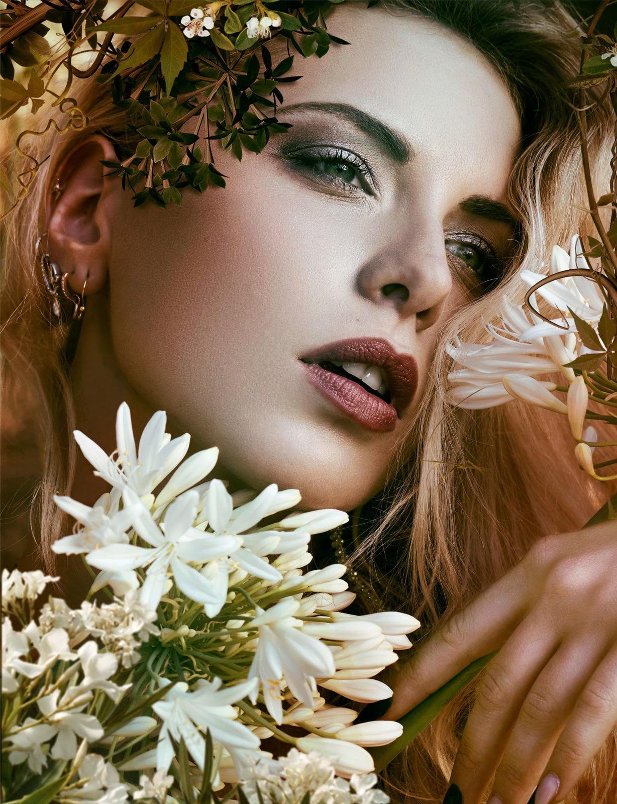 portrait fine art photography of a blonde model surrounded by flowers